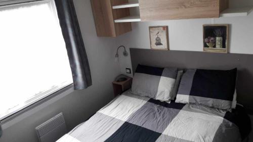 - une petite chambre avec un lit et une fenêtre dans l'établissement 526-Charmettes, aux Mathes