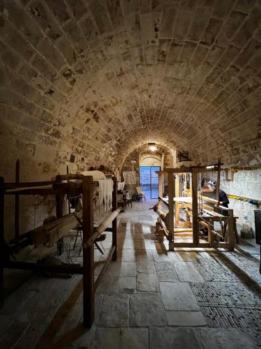 a large room with a stone wall and a tunnel at Sextantio Le Grotte Della Civita in Matera