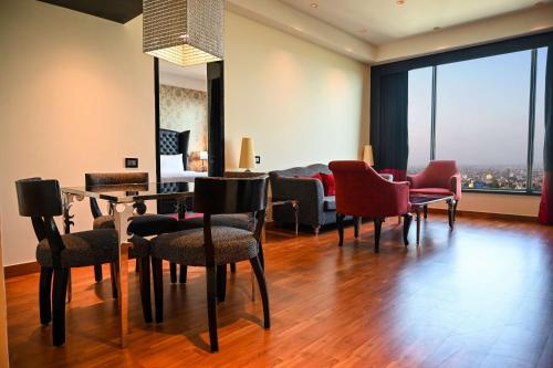a living room with chairs and a table with a view at Radisson Blu Hotel New Delhi Paschim Vihar in New Delhi