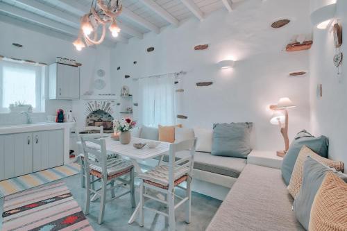 a kitchen and living room with a table and a couch at Villa Amalia at Campos Antiparos in Andiparos