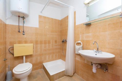 a bathroom with a toilet and a sink at Apartments Luka in Krilo