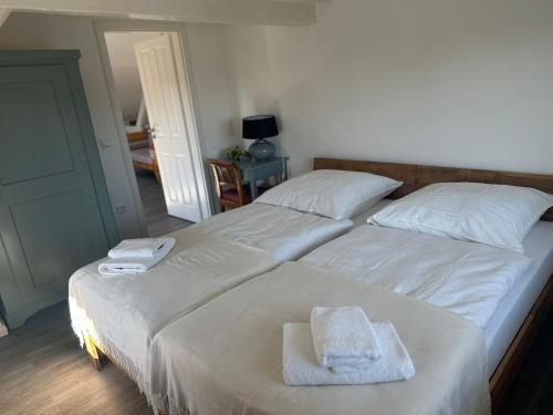 two beds in a bedroom with towels on them at An der Marienbrücke in Lübeck