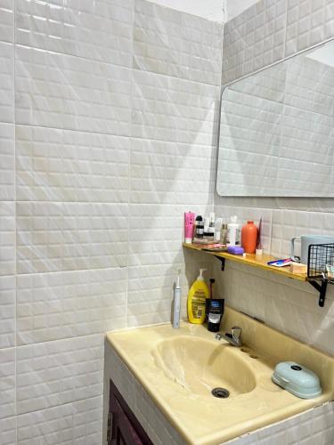 a bathroom with a sink and a mirror at Venn Hostel in Vientiane