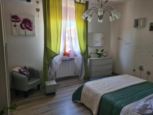 a bedroom with a bed and a window with curtains at Ai piedi del Centro Storico in Castiglione del Lago