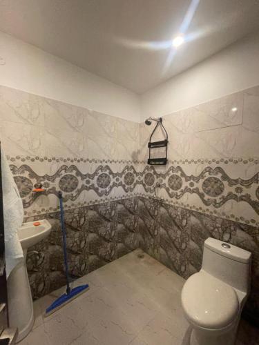 a bathroom with a toilet and a sink at Rural Mitra farms in Noida