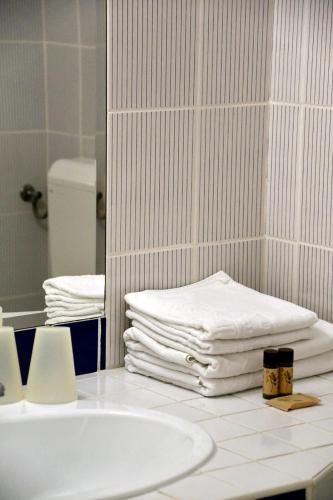 a stack of towels on a counter in a bathroom at Abbazia Country Club in Nemesnép