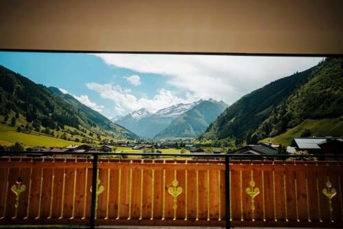 a view from a balcony of a valley with mountains at Carpe Solem Rauris by ALPS RESORTS in Rauris