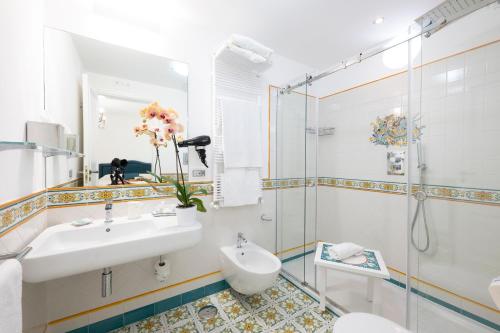 a bathroom with a sink and a shower at Boutique Gimagì in Amalfi
