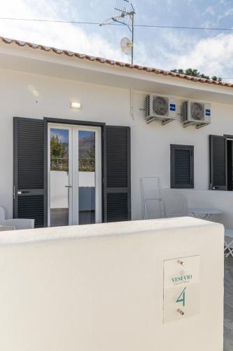 a white house with a view of a patio at Vigna delle Rose in Trecase