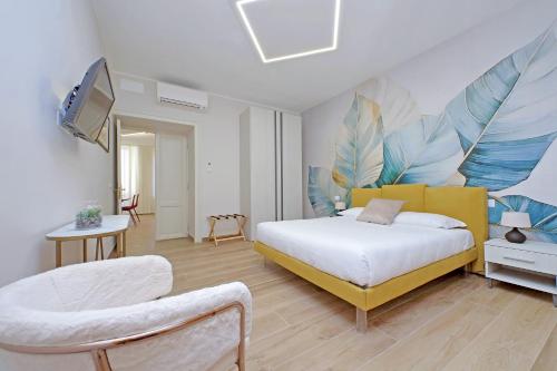 a bedroom with a bed and a tv and a chair at 4BNB - Stylish Spacious Apartment near Vatican in Rome