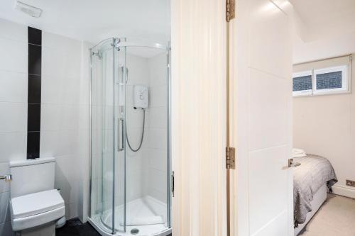 a bathroom with a shower and a toilet at Apt 3, Soho Apartments 2nd & 3rd floors by Indigo Flats in London