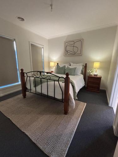 a bedroom with a large bed and a window at The hidden retreat in Doreen
