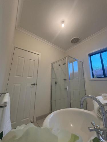 a bathroom with a tub and a shower and a sink at The hidden retreat in Doreen