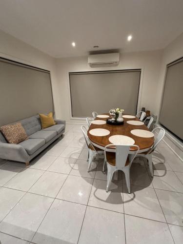 a living room with a table and a couch at The hidden retreat in Doreen