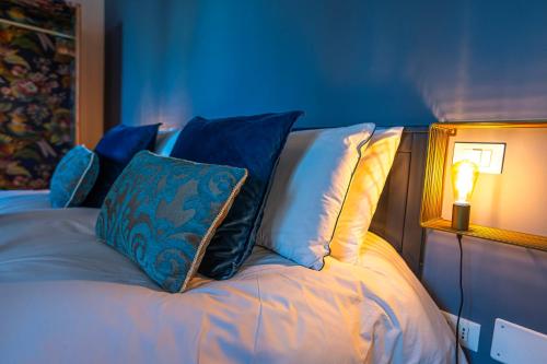 a bed with a pillow and a lamp on it at LaMalatestina Suite - Apartment in front of the Castle in Rimini