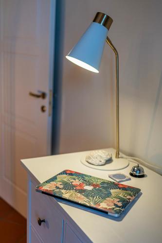 a lamp sitting on top of a table with a pillow at LaMalatestina Suite - Apartment in front of the Castle in Rimini