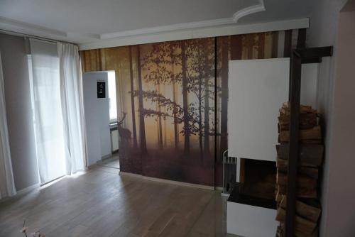 a living room with a wall with a tree mural at TOP Anbindung in den Nationalpark Eifel für 6 Personen und max 2 Hunde inklusive Terrasse in Schleiden