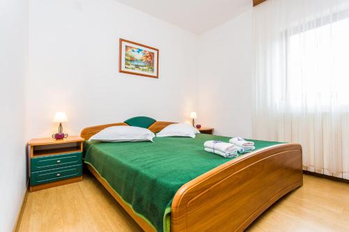 En eller flere senge i et værelse på Guest house Lavanda 2