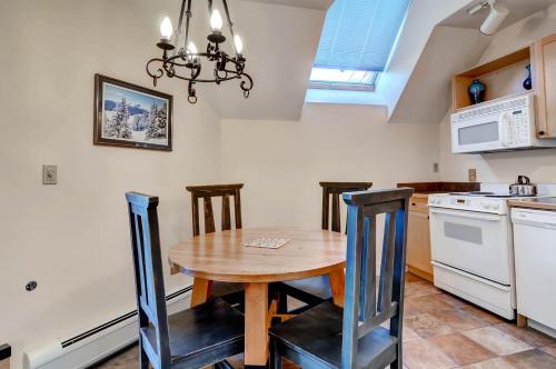 a kitchen with a wooden table and some chairs at River Run Village by Keystone Resort in Keystone