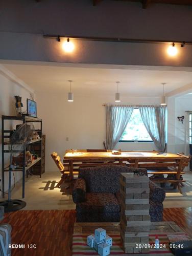 a living room with a table and a couch at CasaClubDescanso in General Rodríguez