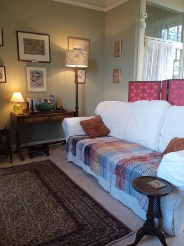 a living room with a couch and a piano at The Old School House B&B in Kelso