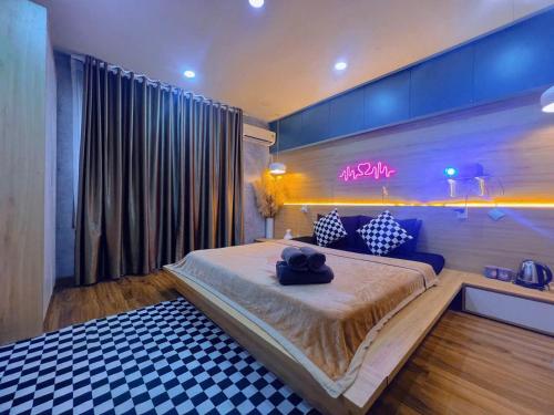 a bedroom with a large bed in a room at MIS HOSTEL Cần Thơ in Can Tho