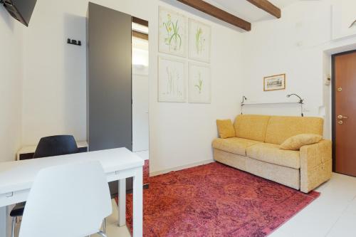 a living room with a couch and a table at Porta Genova - Navigli - Monolocale in Milan