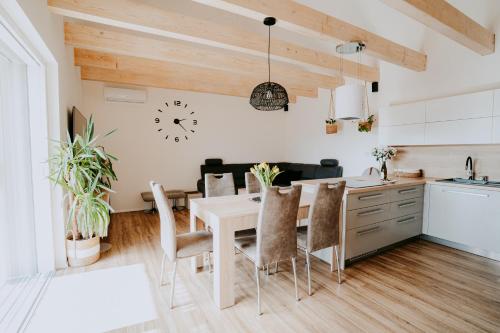 a kitchen and dining room with a table and chairs at Ubytování Ve dvorku in Uherčice