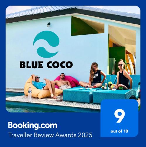 a group of people sitting in front of a blue coo sign at Blue Coco in Keramas