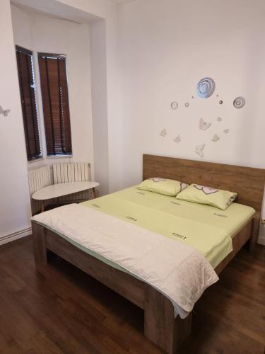 a bedroom with a bed and a chair in it at Great Black Sea View in Constanţa
