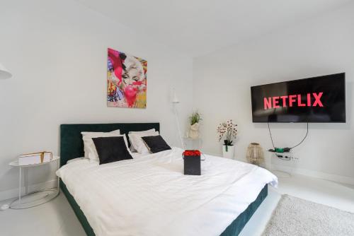sypialnia z łóżkiem z napisem netflix na ścianie w obiekcie Lumina lux apart near Muzeum Powstania w Warszawie