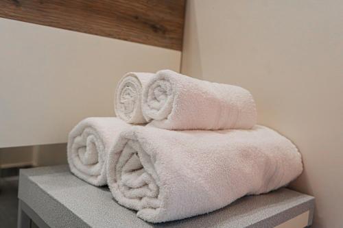 a stack of towels sitting on top of a counter at LovelyHouseBraida in Milan