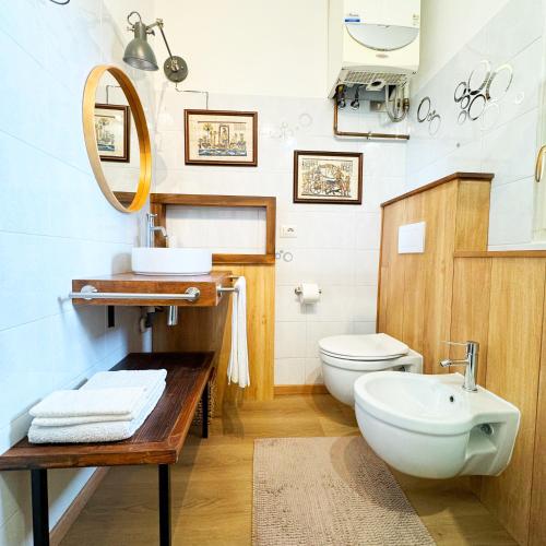 a bathroom with a toilet and a sink and a mirror at Vista Lago - Lake Como collection in Domaso