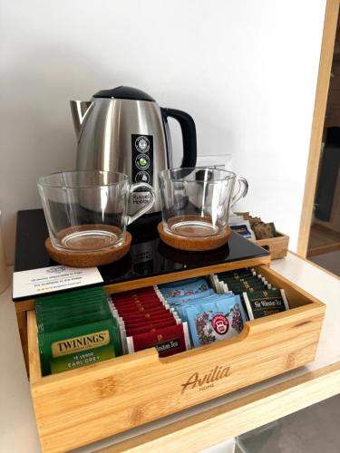 a wooden tray with two glasses and a coffee maker at Scugnizzo Apartment in Naples