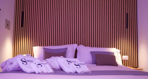 a bedroom with a bed with towels on it at Scugnizzo Apartment in Naples
