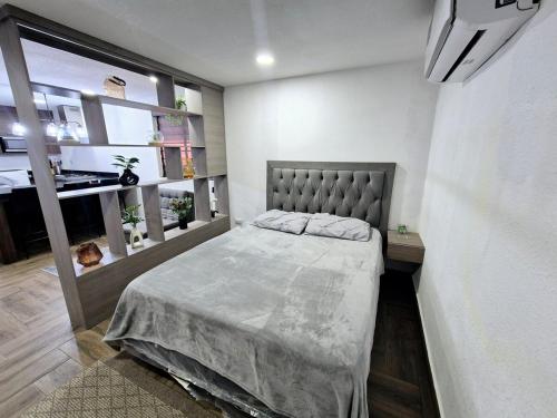 a bedroom with a large bed in a room at Elegante Loft Pitagoras 1 in San Lorenzo