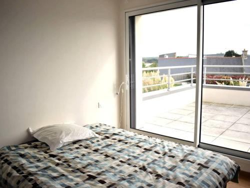 une chambre avec un lit et une grande fenêtre dans l'établissement Superbe villa avec WIFI et grand jardin à 300m de la plage à l'Ile Grande, proche Club Nautique - FR-1-368-129, à Pleumeur-Bodou