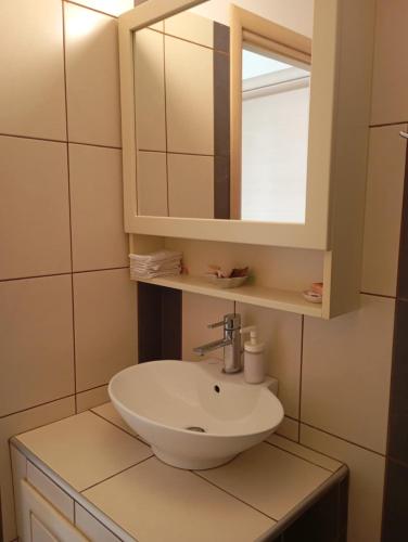 a bathroom with a sink and a mirror at Nea Peramos Breeze in Nea Peramos