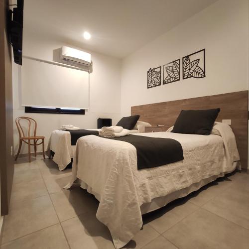 En eller flere senge i et værelse på Departamentos Arenales