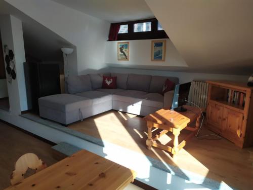 a living room with a couch and a table at Oasi di Pace vicino Sestriere in Champlas du Col