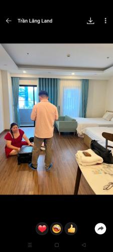a man standing in a living room with a woman at Your House Quy Nhơn FLC in Quy Nhon