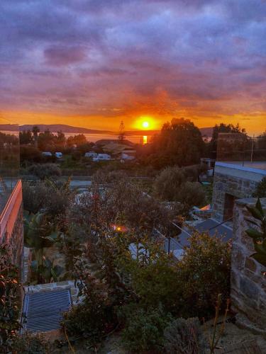 a sunset from the roof of a building at Gialova SUNSET VILLA with Seaview & Private Pool in Gialova