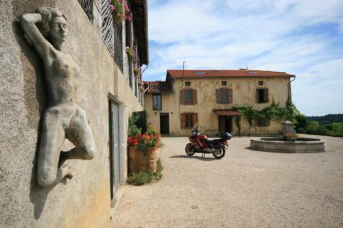 a statue of a man on a motorcycle next to a building at Naturist Hotel Peyraille in Libaros