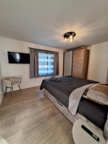 a bedroom with a large bed and a window at Murtal Appartement Top 4 in Zeltweg