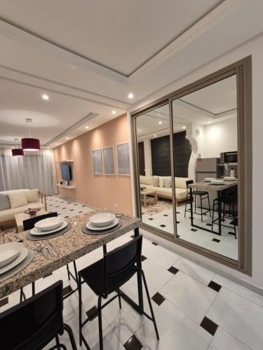 a kitchen and living room with a table and chairs at RABAT Residence - AGDAL STAY in Rabat