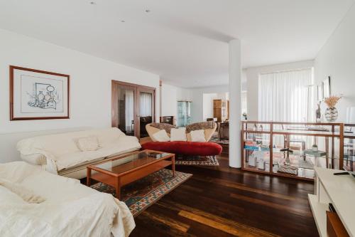 a living room with a couch and a table at Viana Beach Surf House in Viana do Castelo