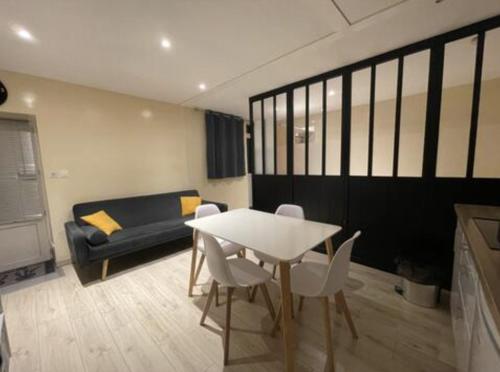 un salon avec une table, des chaises et un canapé dans l'établissement Cabana, à Mâcon