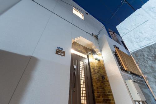 a door to a building with a sign on it at Y's INN アネックス 012T in Tokyo
