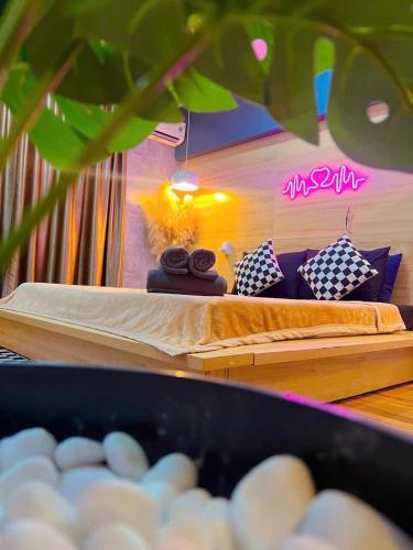a room with two beds and pillows on a table at MIS HOSTEL Cần Thơ in Can Tho