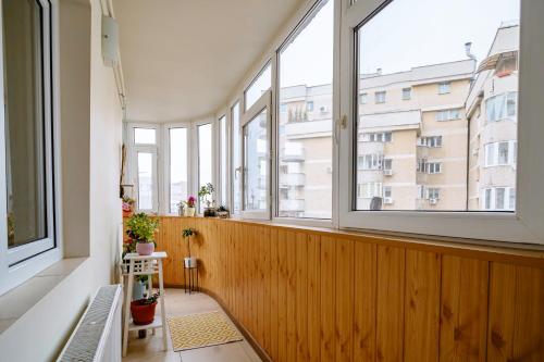 an empty room with windows and a bench in front at The QUARK Modern Designed 2BR Central Apartment in Craiova